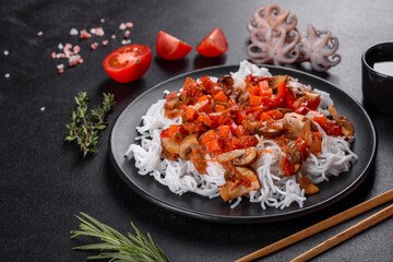 Tasty rice noodles with tomato, red pepper, mushrooms and seafood