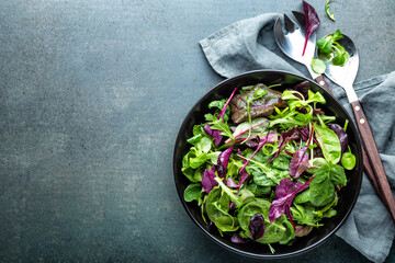 Salad bowl, healthy food. Fresh salad mix of baby spinach, arugula leaves, basil, chard and lambs lettuce. - 397679771