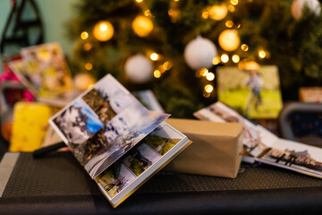 Naklejka na ściany i meble family photo album near the Christmas tree