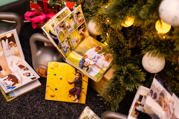 Naklejka na ściany i meble family photo album and weights for sports near the Christmas tree
