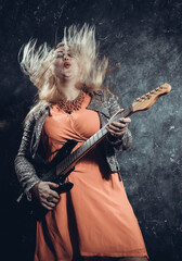 Attractive plump rocker woman with electric guitar