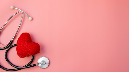 Black stethoscope with red heart of doctor for checkup on pink background. Stethoscope equipment of...