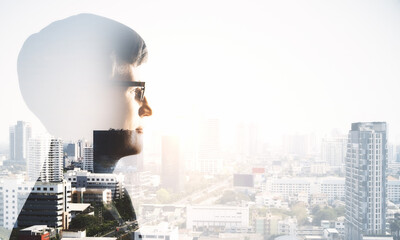 Young silhouette businessman hand on modern city background.