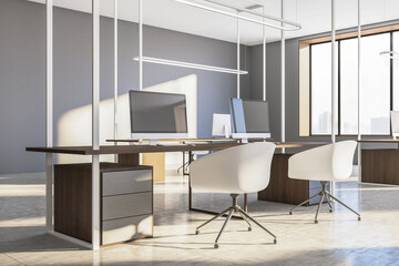 Workplace with two computers on table and city view