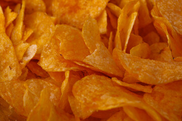 Potato chips or crisps . Close-up of potato chips or crisps. Food background.