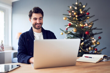 Young man working remotely during Christmas at home