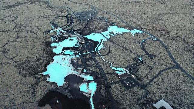 Blue Lagoon, Iceland. Aerial view of contrasting dark soil and blue water. Hot springs - view from above. High quality 4k footage