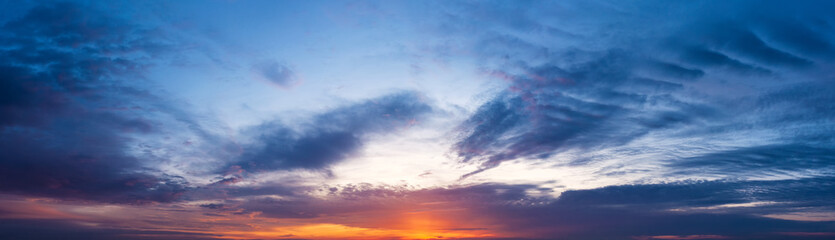 Naklejka na ściany i meble Panoramic shot of a beautiful sky at sunset.