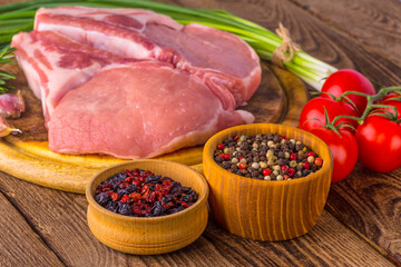 fresh raw new-york steak on wooden Board on wooden background with salt and pepper in a rustic style.