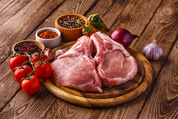 fresh raw new-york steak on wooden Board on wooden background with salt and pepper in a rustic style.