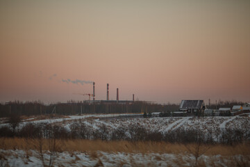 factory smokestacks on the horizon