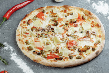 Seafood pizza. pizza with mozzarella, shrimp, octopus, squid, mussels and other seafood.