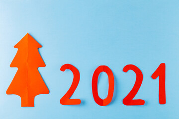 Christmas tree on a blue background. Red New Year tree made of paper. New Year's concept 2021. Top view
