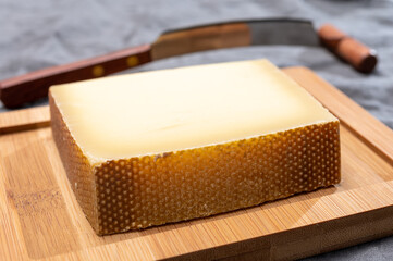 Block of Swiss medium-hard matured cheese gruyere used for baking, quiche, fondue, sandwiches
