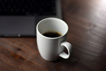 Cup of coffee and notebook on a wooden office table
