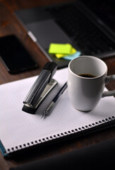 Coffee and office supplies on a wooden table