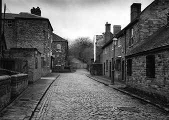 Old cobbled street and houses
