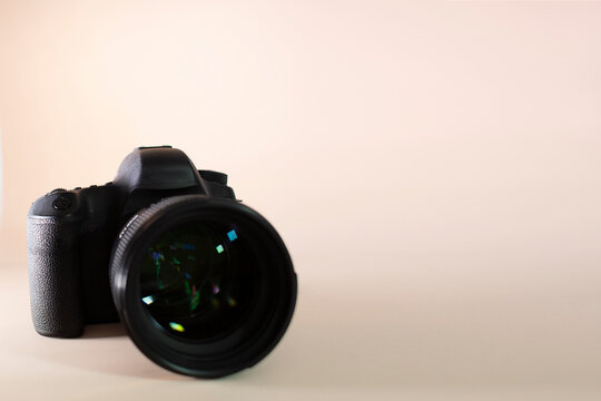 DSL camera with lens - White background - Copy space