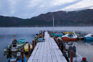 A lake in the Mt Fuji Region called, The Five Lakes, can be seen in the early morning in Autumn, It is cold and mist is rising from the water surface and frost is on the ground. Japan
