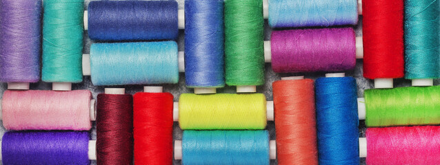 Sewing threads on spools of different colors