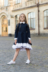 Adorable kid wear elegant school dress with formal look in schoolyard, uniform