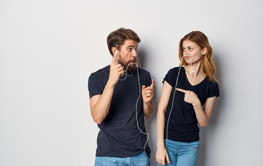 young couple in headphones listening to music fun friendship emotions