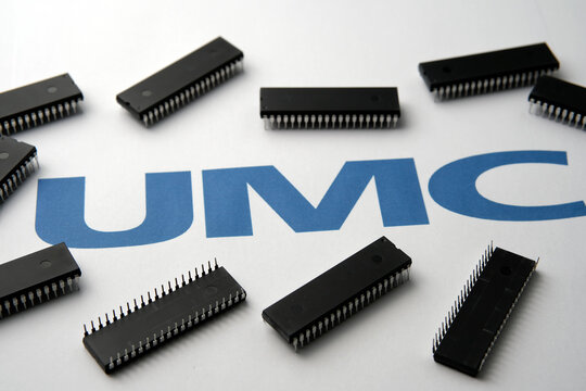 United Microelectronics Corporation. Semiconductors chips and blurred UMC logo. Stafford / United Kingdom - October 22, 2020: 