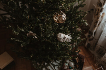 Christmas tree decorating. Holiday time. Lights, ornaments, vintage retro decor. Green fur tree. Merry Christmas, Happy New Year. Authentic tree ornaments. Holiday is over. Pack stuff to the boxes.
