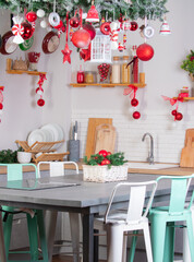 kitchen decorated for the new year with red Christmas balls