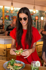 beautiful woman eating street food in barcelona
