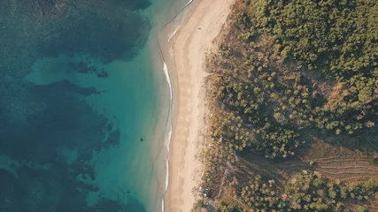 Fotobehang Slaapkamer Top down of tropic seascape at sand beach aerial. Nobody nature landscape of green tropical forest at sandy ocean shore. Majestic sea bay water scape with exotic plants at seashore  © Goinyk