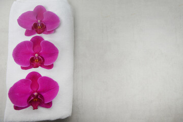 Fototapeta na wymiar Red three orchid flower on white towel with copy space