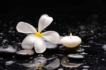 Obraz na płótnie Canvas spa still life of with frangipani with candle and zen black stones ,wet background 