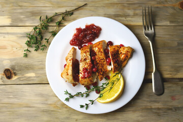Turkey fillet with cranberry sauce presented on a plate. Christmas dinner. Healthly food.