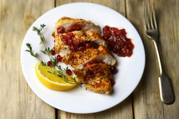 Turkey fillet with cranberry sauce presented on a plate. Christmas dinner. Healthly food.