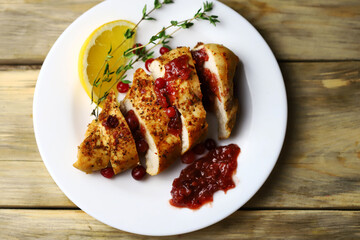 Turkey fillet with cranberry sauce presented on a plate. Christmas dinner. Healthly food.