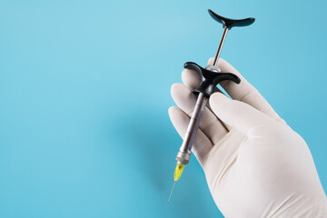 Dentistry medical tools syring on blue background.