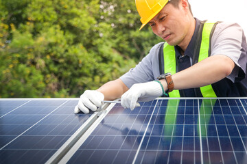 Asian technicians install panels Solar cells to produce and distribute electricity. Energy technology concept