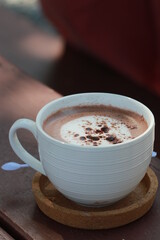 Close up hot chocolate in white ceramic cup