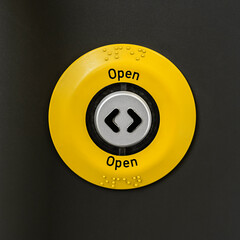 Generic yellow OPEN button on a train door shot straight on and close up.