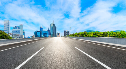 Empty asphalt road and Shanghai skyline with buildings scenery.