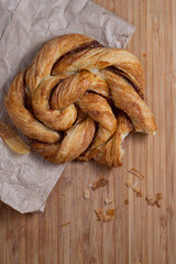 Cardamom Bun twist on paper bag with bite out