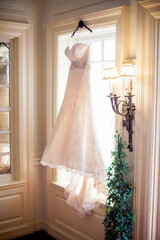 bridal dress hanging in a window
