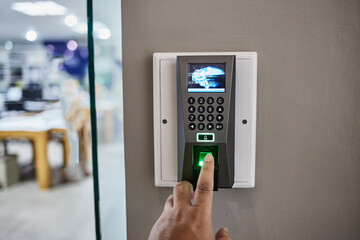 Yong man press down the finger on fingerprints scan machine to access the door security systems. Selective focused