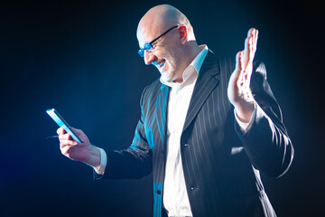 Happy man with a tablet in his hands. A satisfied man is talking via video calling. Call using...
