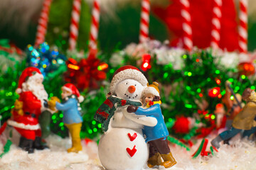 Fototapeta na wymiar Christmas holiday decorations scene child hugging a snow man