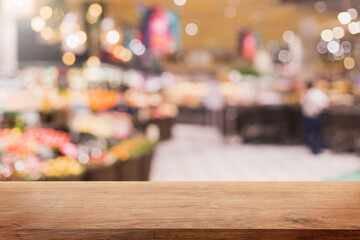 Empty wood table top and blurred supermarket and grocery store interior background - can used for display or montage your products.