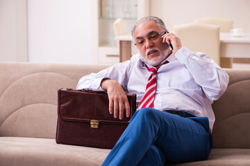 Fototapeta premium Old male boss employee coming home from work