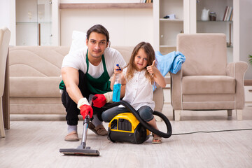 Young male contractor cleaning the house with his small daughter