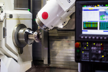 CNC milling or turning machine cutting bevel gear with milling spindle. Mutitasking CNC lathe machine. Industrial manufacturing machinery